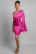 Woman wearing a pink one-shoulder dress against a white background